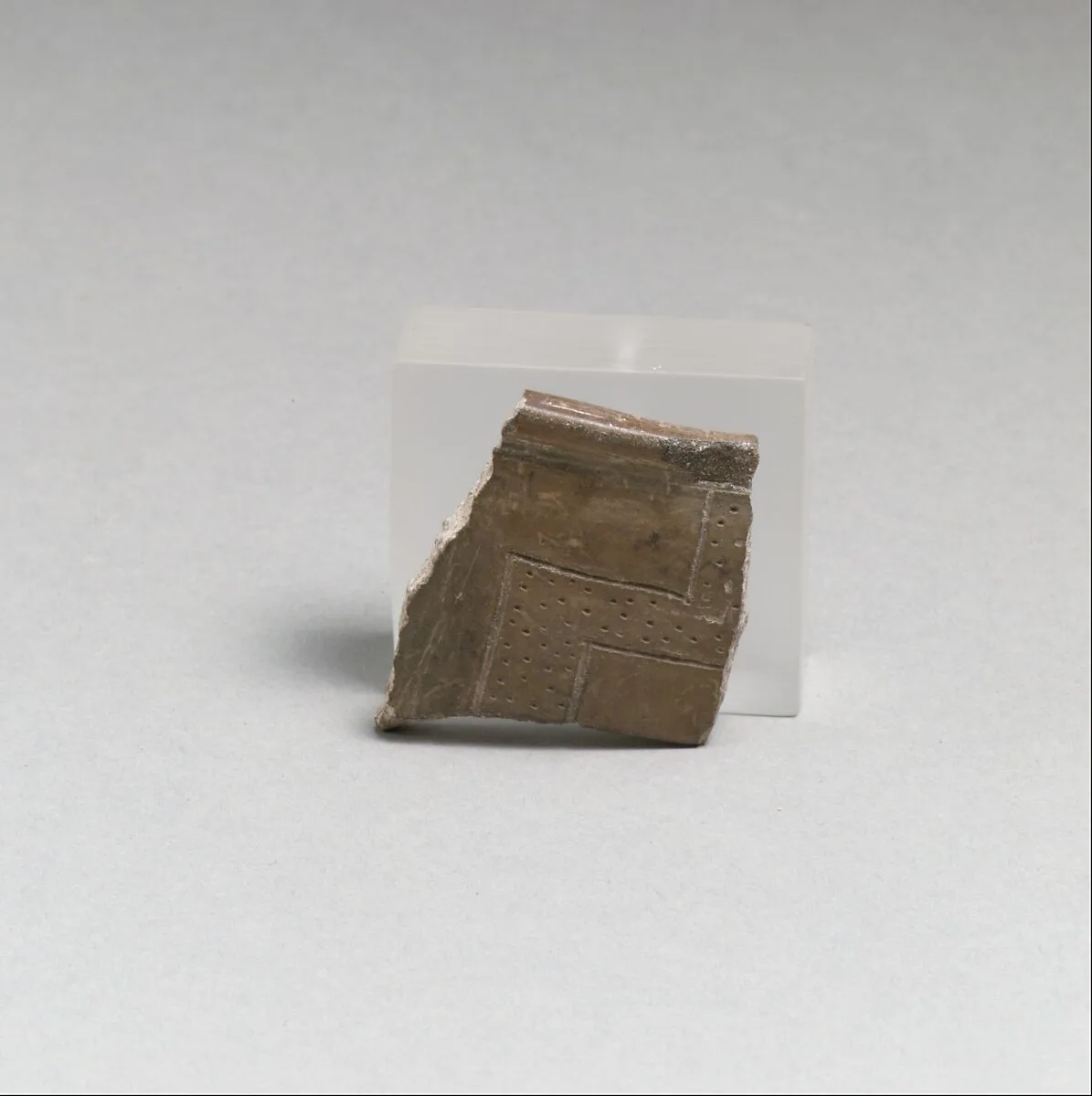 Terracotta rim fragment with incised lines and punctations — Unknown