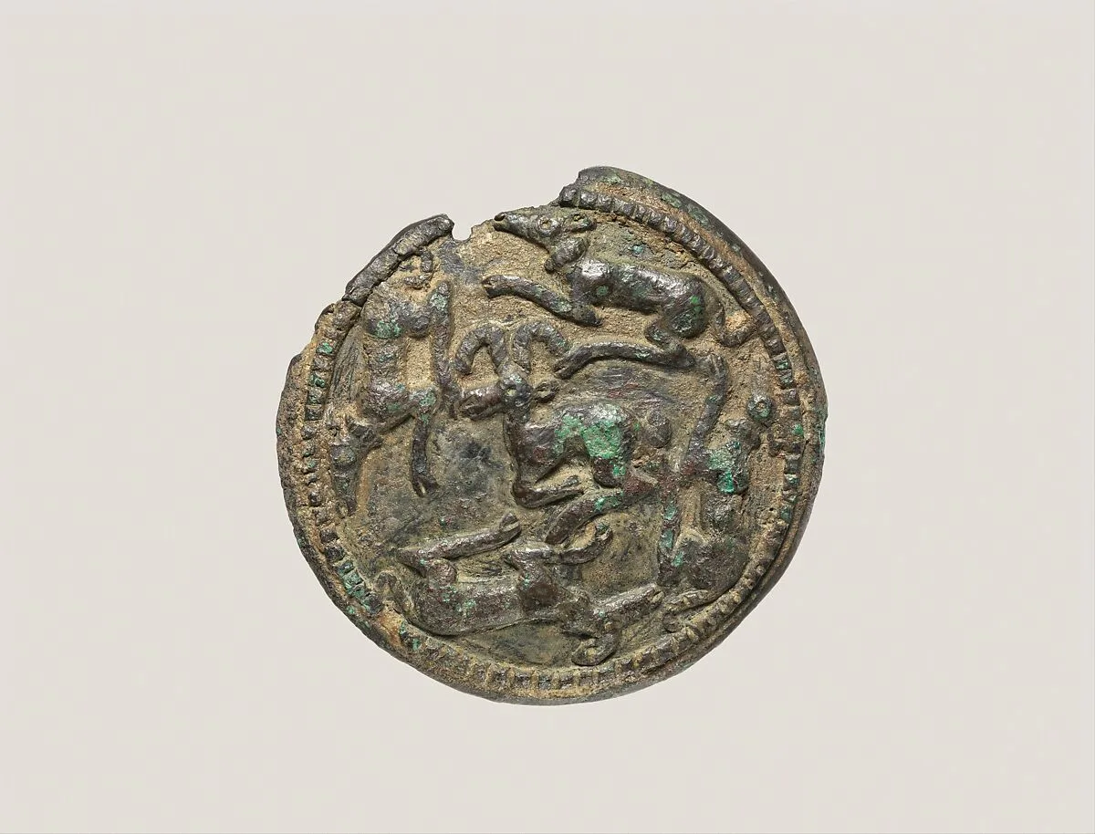 Disc with running dogs surrounding a mountain goat — Unknown