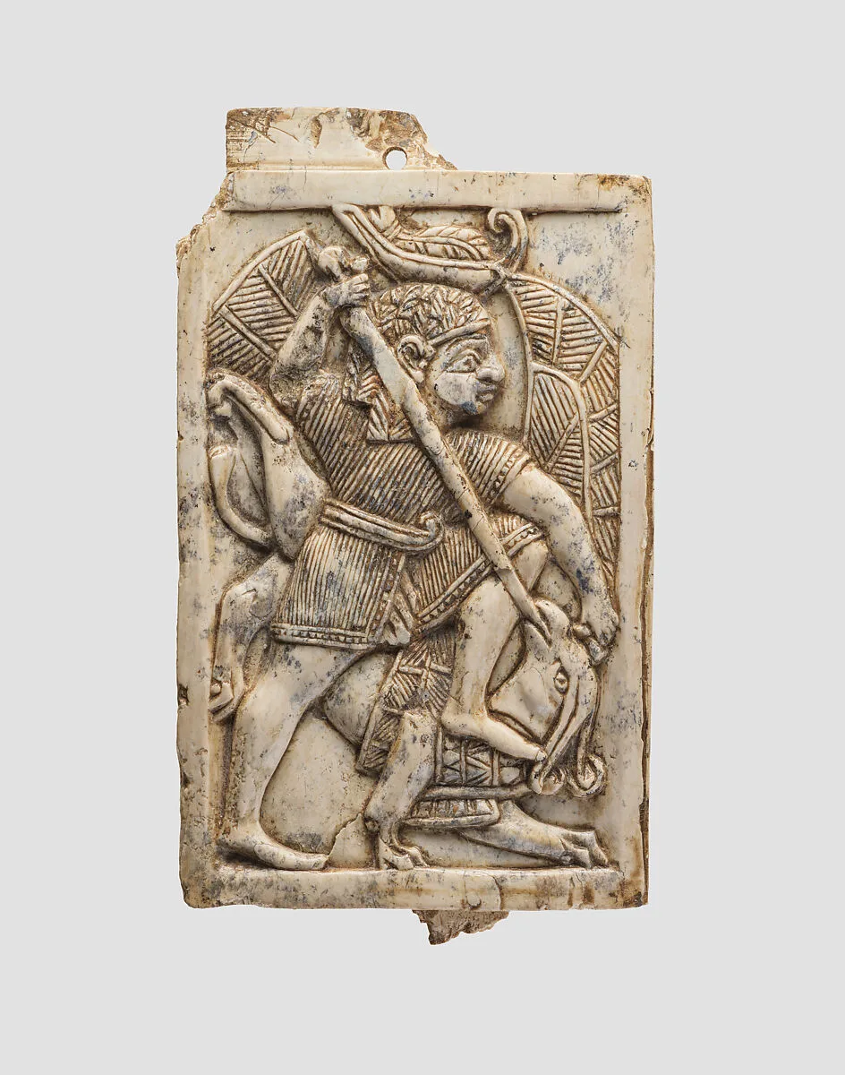 Furniture plaque carved in relief with a male figure slaying a griffin — Unknown