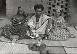 Maure man with his wife and mother before a tea set — Unknown