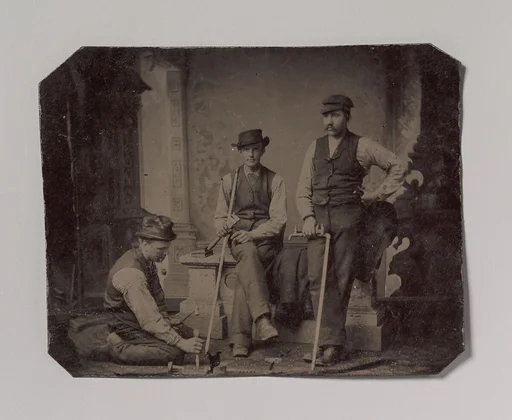 [Three Plumbers with Pipes and Tools]