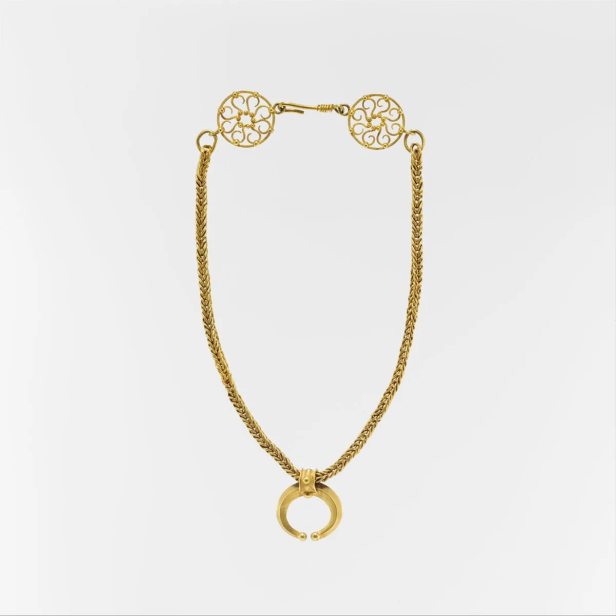 Gold necklace with crescent-shaped pendant — Unknown