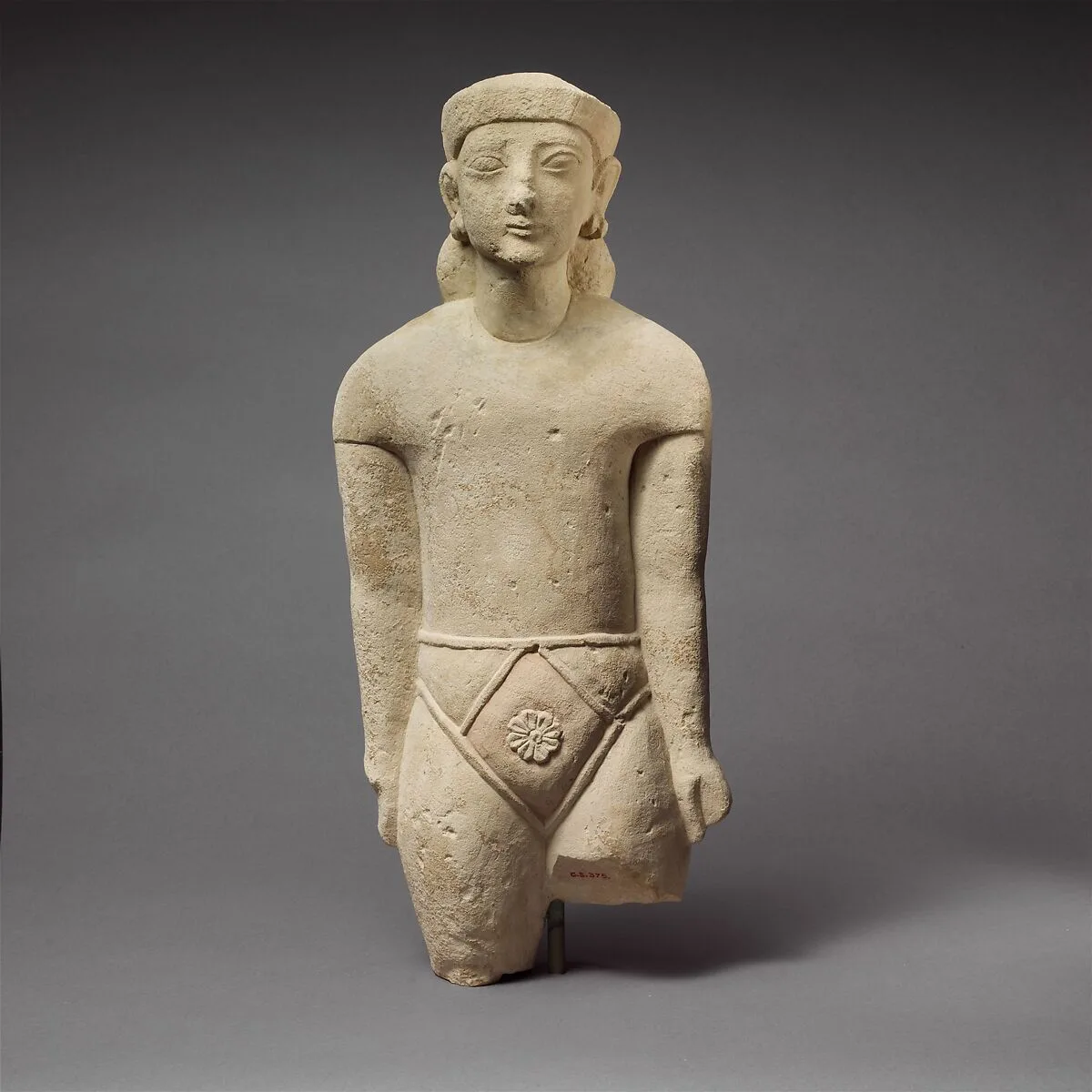 Limestone statuette of a male votary with Cypriot shorts and a diadem — Unknown