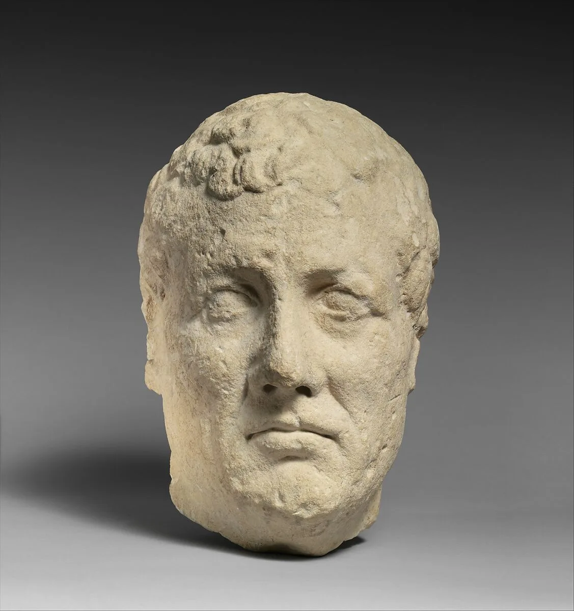 Limestone head of beardless male votary — Unknown