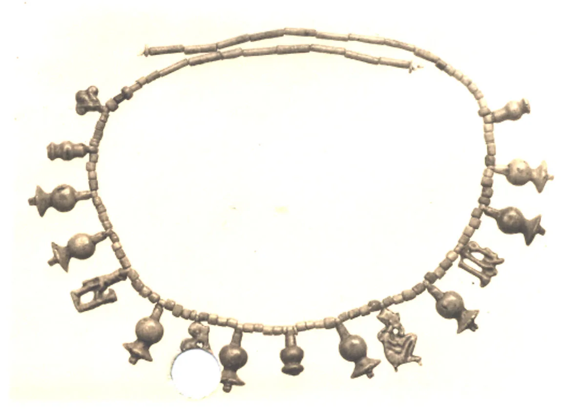 String of beads and amulets — Unknown
