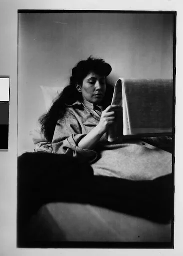 [Two 35mm Film Frames: Jane Smith Evans Reading Newspaper in Bed, New York City]