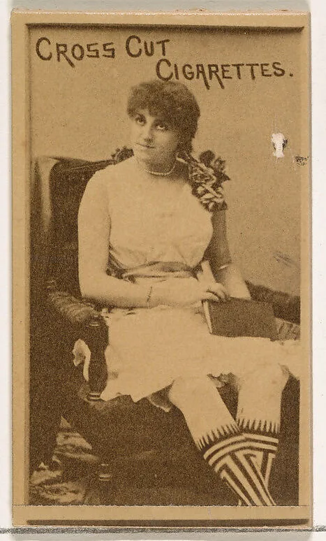 Seated actress wearing patterned stockings, from the Actors and Actresses series (N145-1) issued by Duke Sons & Co. to promote Cross Cut Cigarettes — W. Duke, Sons & Co.