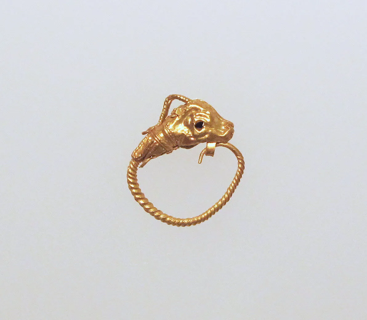 Gold earring with head of an antelope — Unknown