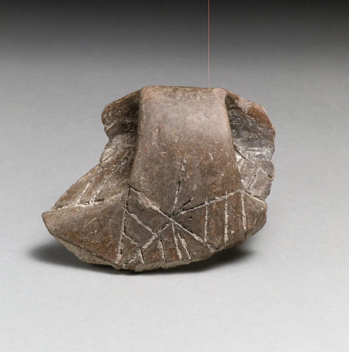 Terracotta rim fragment with handle and incised decoration — Unknown