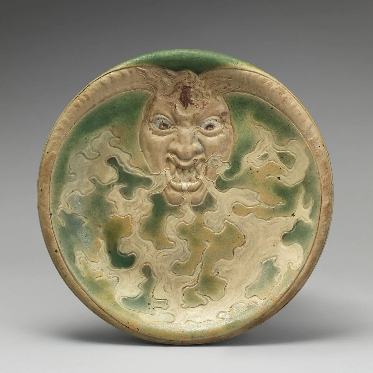 Dish with devil's head design — Emile Muller and Co.