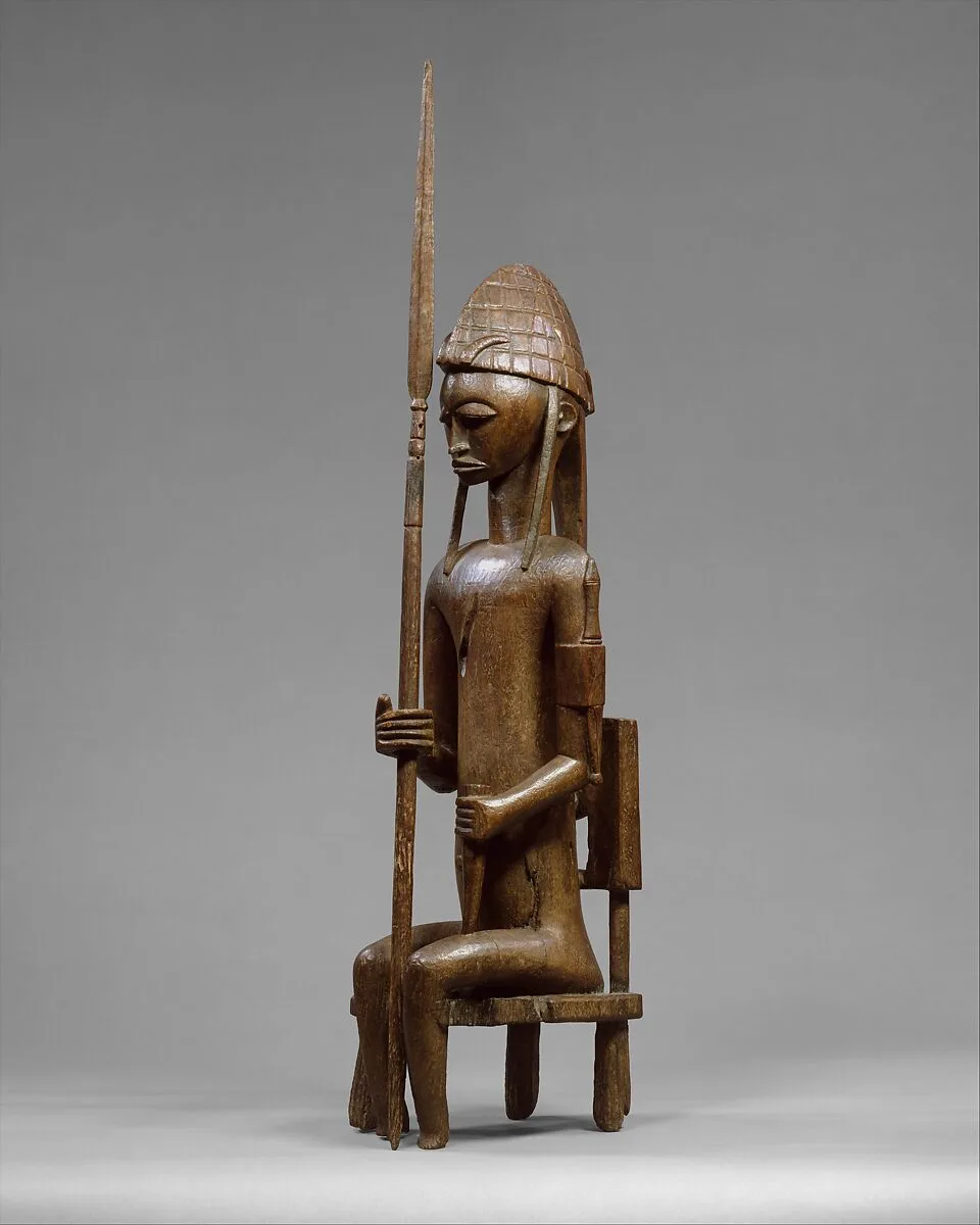 Seated Male Figure with Lance — Unknown