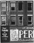 [Façade of Brick Building with Men's Clothing Advertisement]