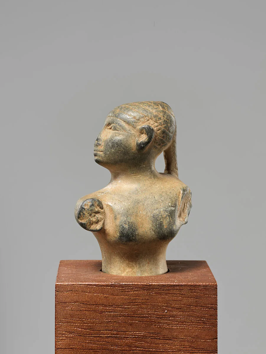 Statuette of a female figure with a braid — Unknown