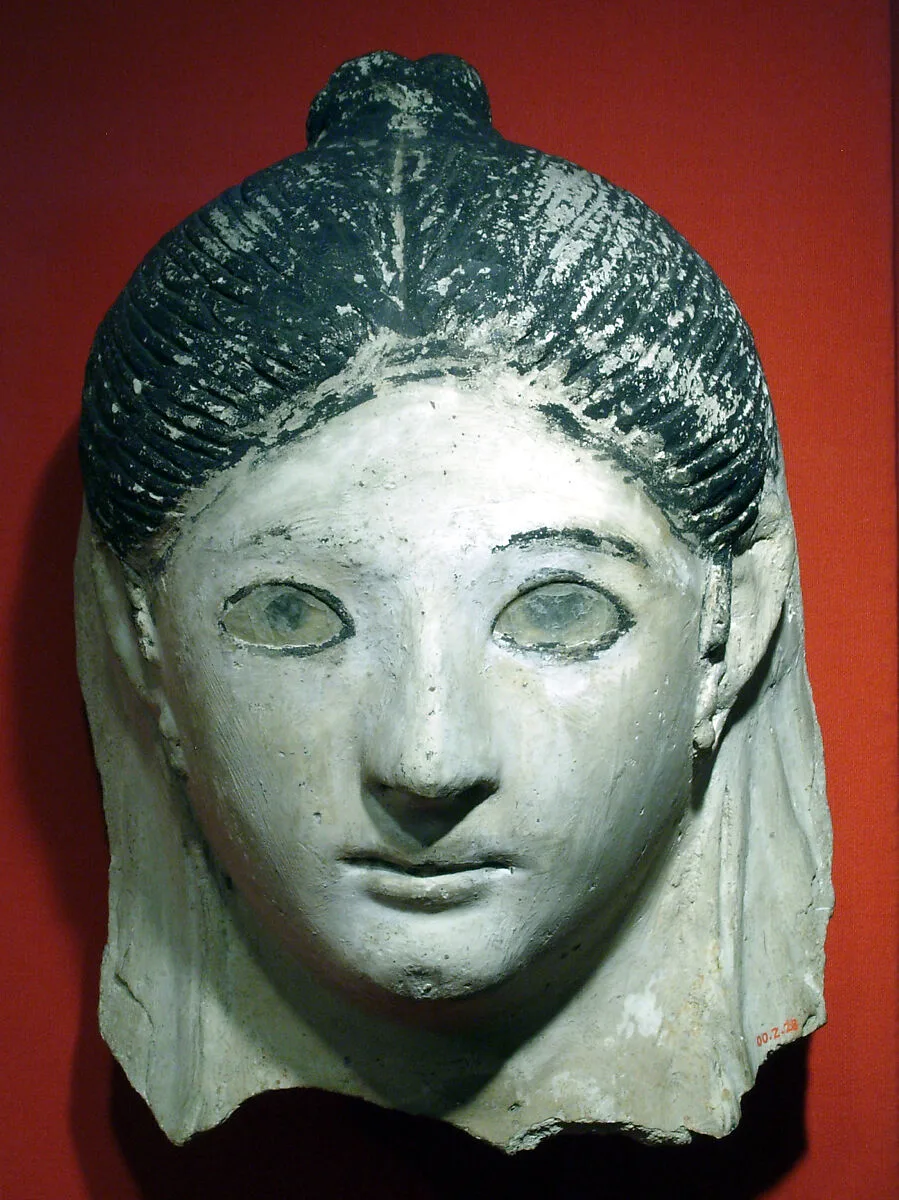 Mask of a woman with her hair in a small knot — Unknown
