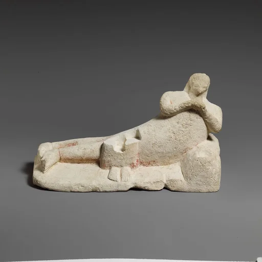 Limestone group of a male banqueter and a woman