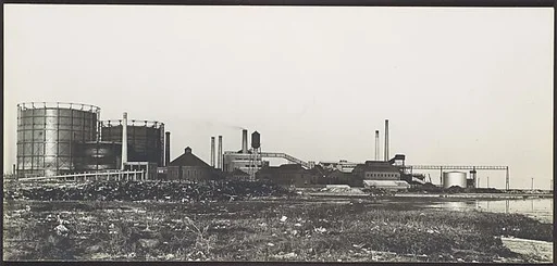 [Industrial Site: Smokestack and Oil Tanks]