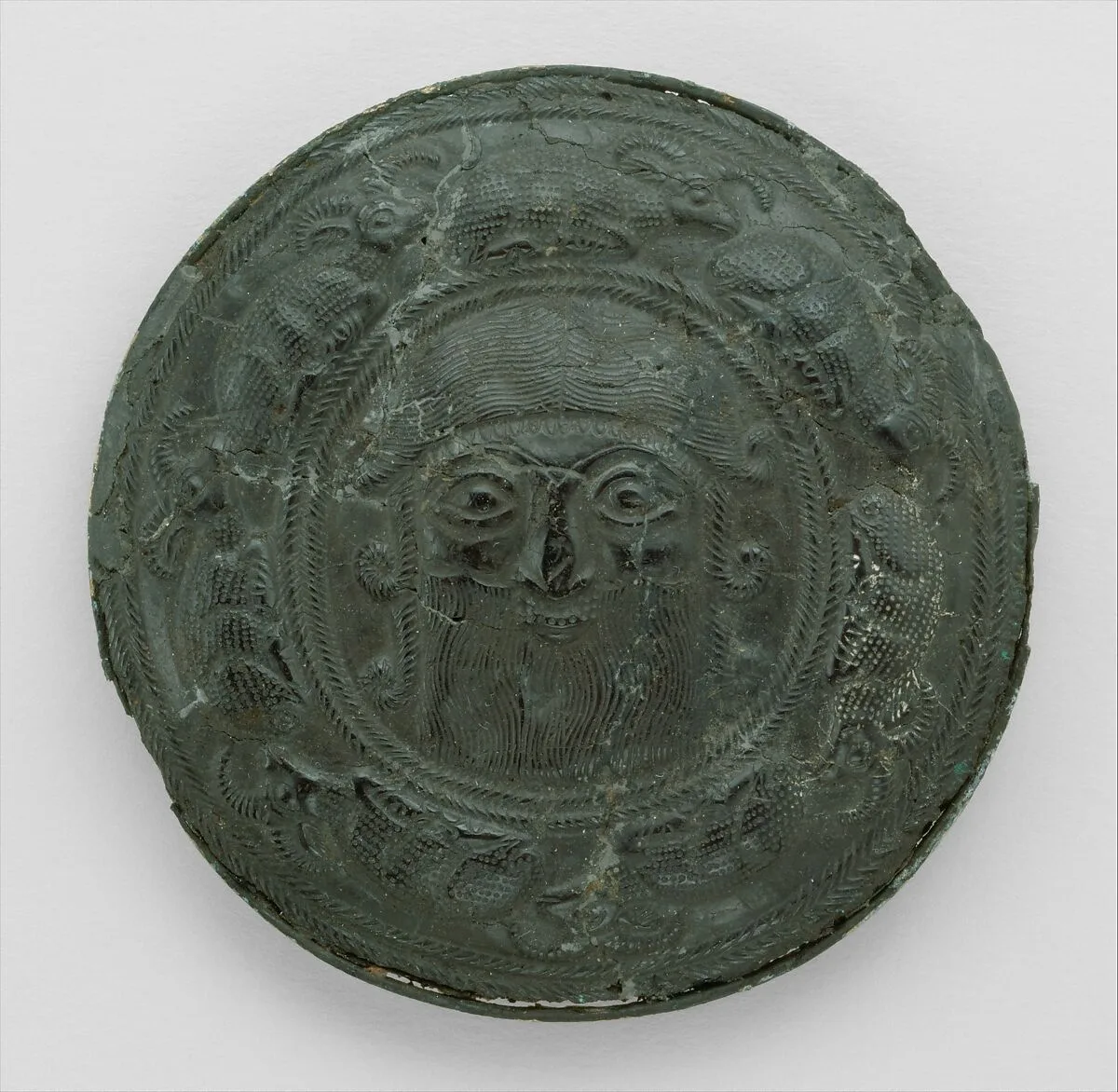 Roundel with head of a "hero" surrounded by caprids — Unknown