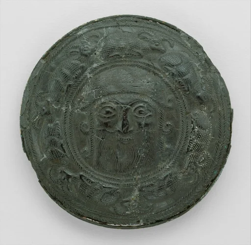 Roundel with head of a "hero" surrounded by caprids