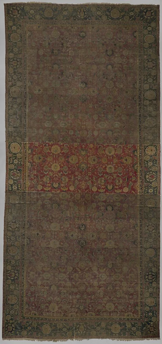 Indo-Persian carpet with repeat pattern of vine scrolls and palmettes. — Unknown
