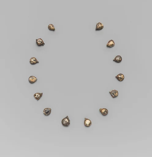 Fourteen pendants for a necklace