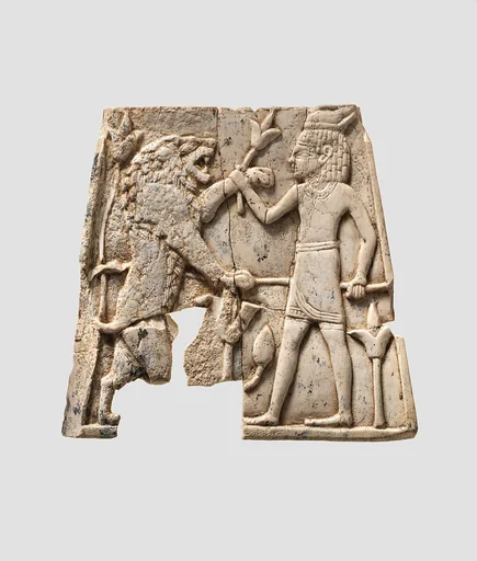Plaque carved in relief with figure fighting a lion