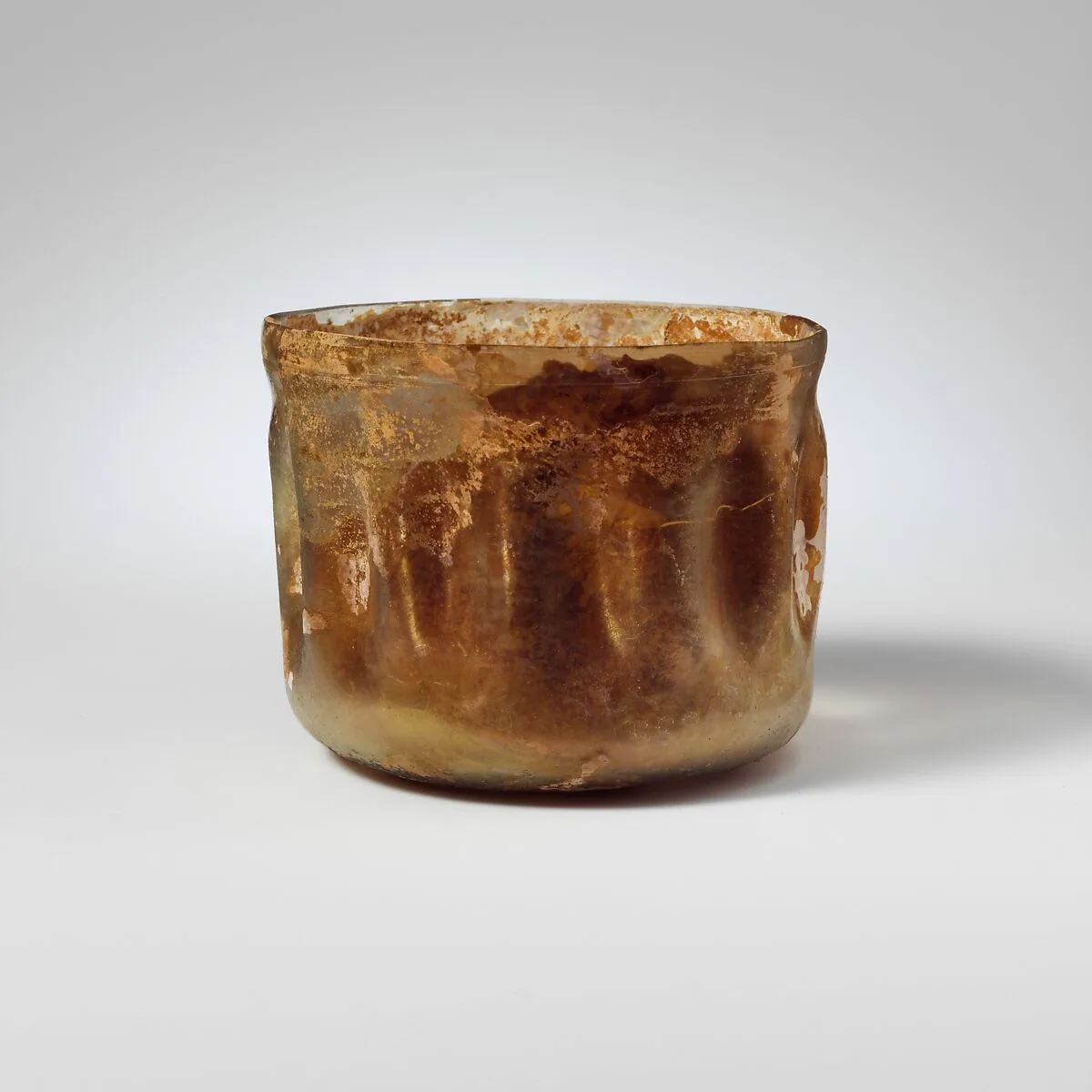 Glass cup with indented sides — Unknown