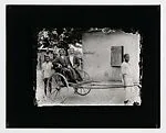 Two dapper young men in pull cart — Alex Agbaglo Acolatse