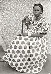 Young Woman Seated in Apple Print Dress — Seydou Keïta