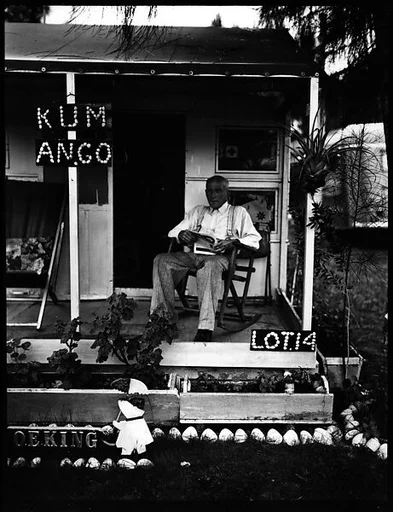 [Man on Porch of House with Sign "KUM ANGO" in Municipal Trailer Camp, Sarasota?, Florida]