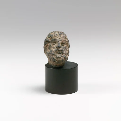 Bronze head of a bearded man or god