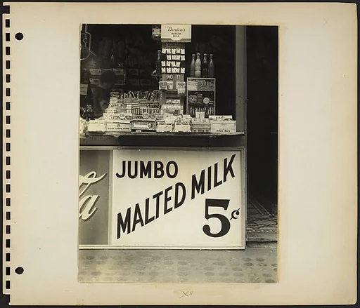 [Cigar and Candy Stand with Painted Sign "JUMBO MALTED MILK 5¢", New York City]