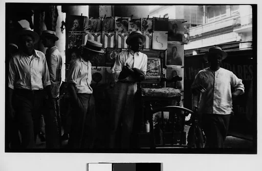 [Young Men in Front of Newspaper Kiosk, Havana]