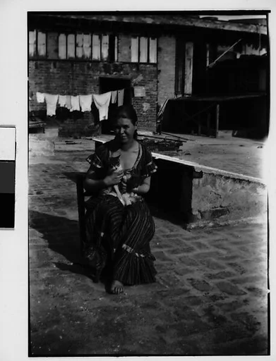 [Seated Woman with Cats on Roof, New York City (?)]