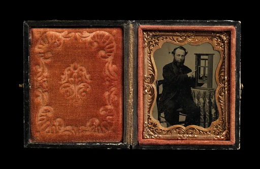 [Seated Man Demonstrating Vertical Sliding Window Model]