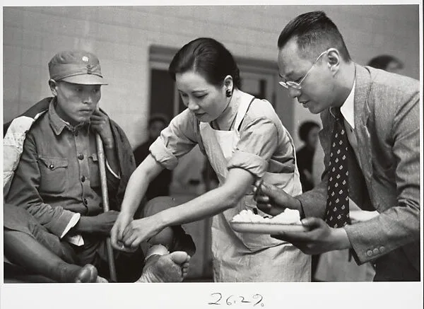Mme. Chaing Kai-shek caring for the wounded. Hankow — Robert Capa