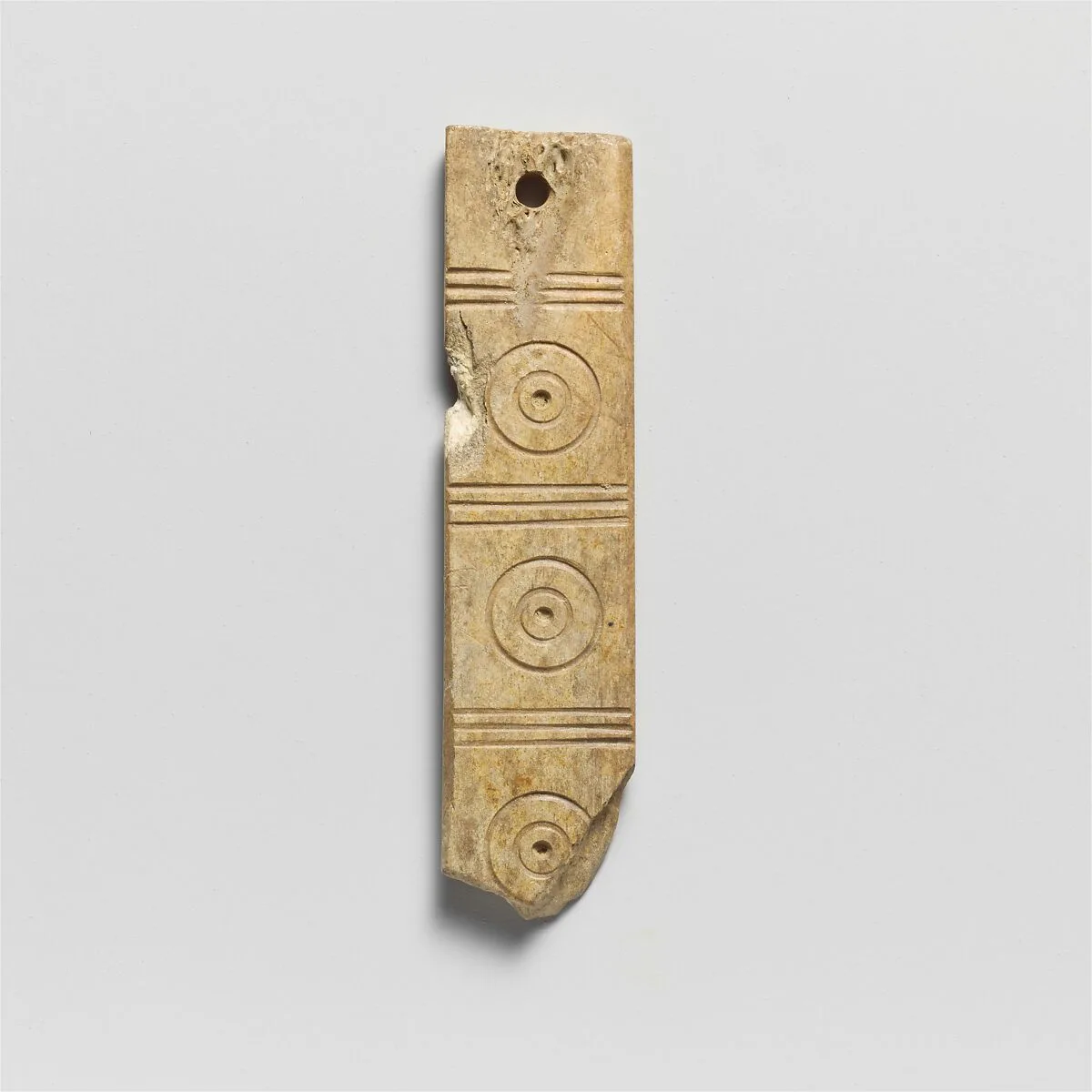 Bone plaque with a hole at one end — Unknown