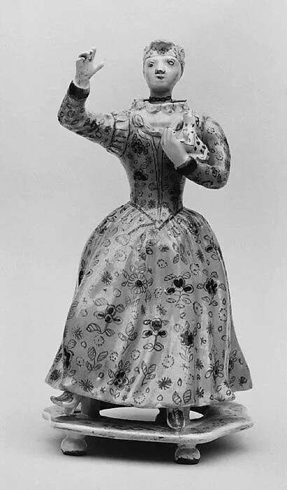 Standing woman holding a dog — Unknown