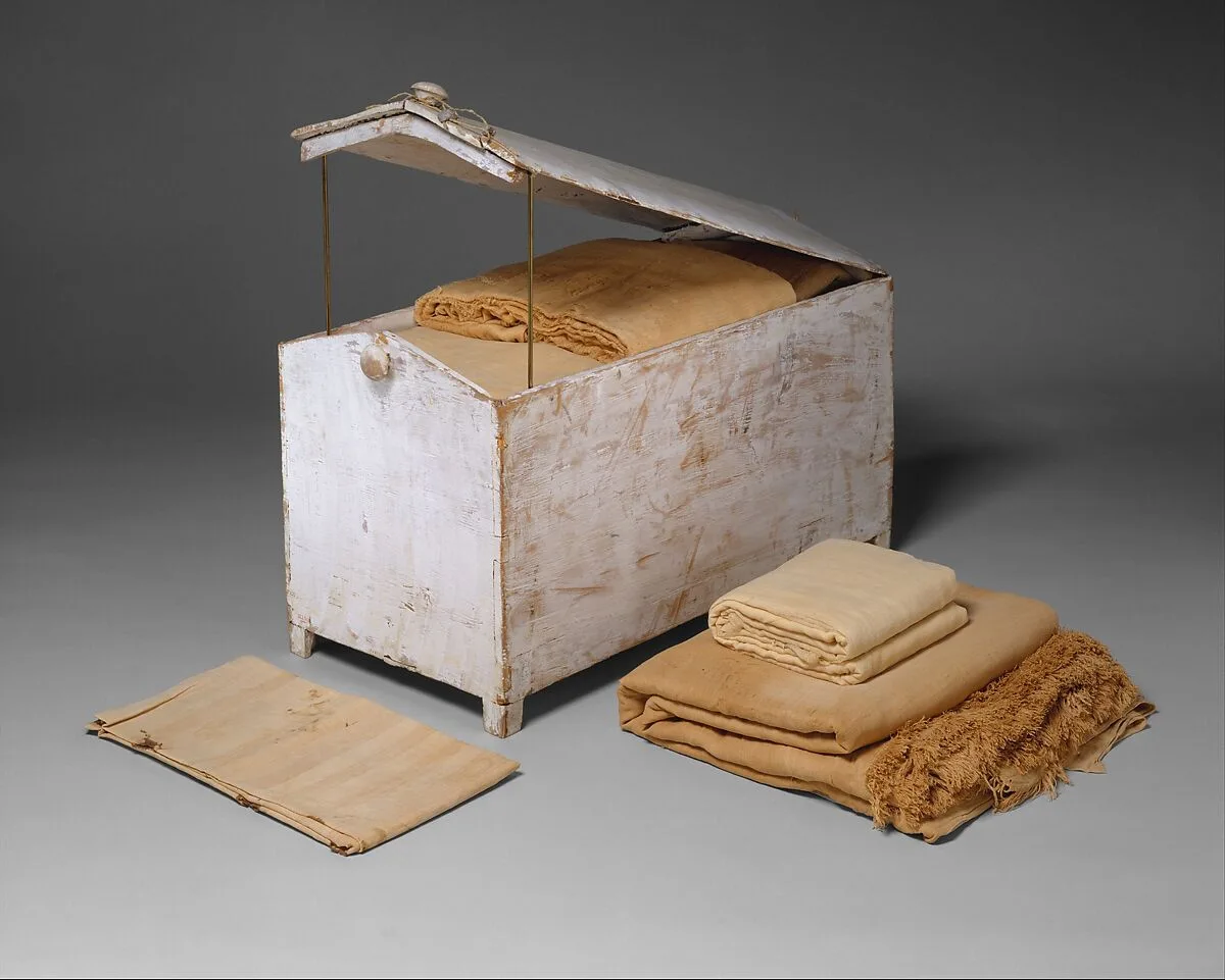 Gable–topped chest and linens — Unknown