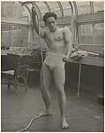 [Male Model Posed Pulling a Rope in Anna Huntington's Rooftop Studio]