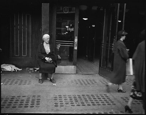 [Woman Begging Outside Entrance of S. Klein-on-the-Square Department Store, Union Square East, New York City]