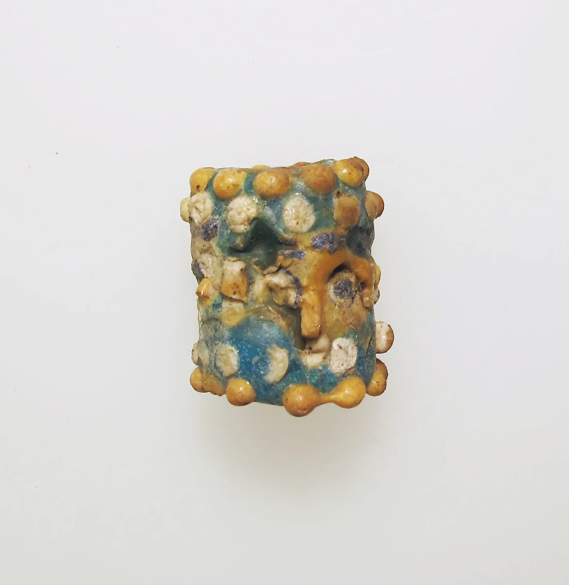 Glass face bead — Unknown