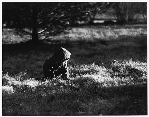 [Boy Wearing Hooded Jacket, Seated in Grass]