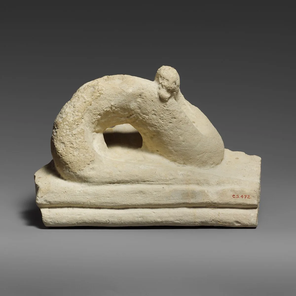 Two fragments of a limestone sarcophagus lid with snakes — Unknown