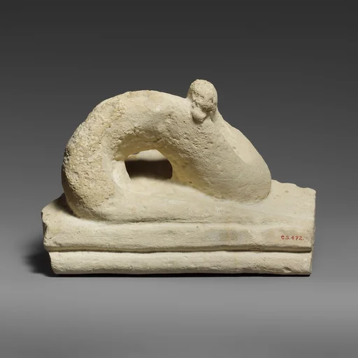 Two fragments of a limestone sarcophagus lid with snakes