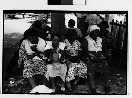 [Two 35mm Film Frames: Women Seated on Amusement Park Benches]