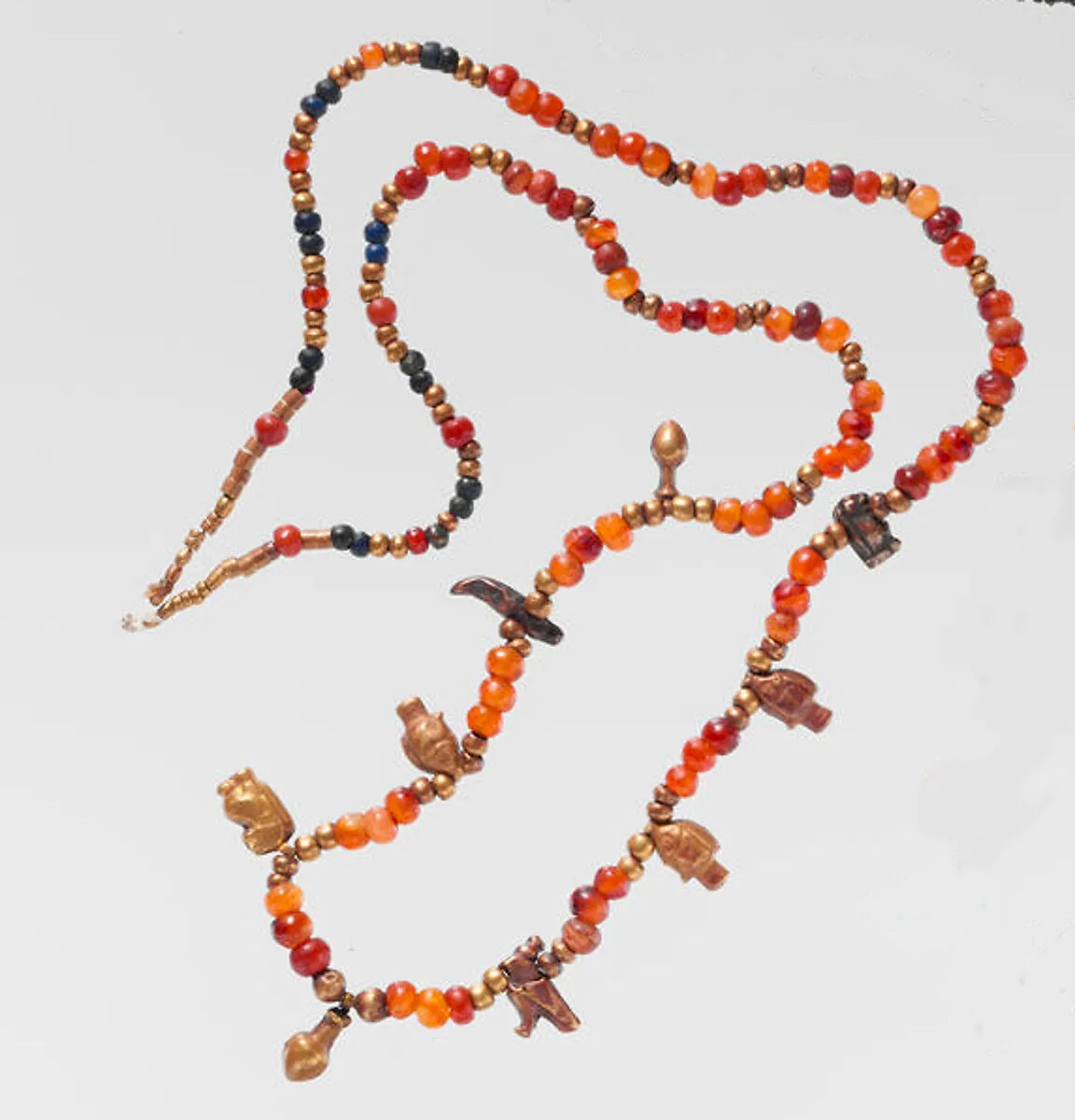 Necklace of ball beads and gold amulets — Unknown