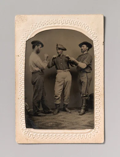 [Two Men in Boxing Stance, a Third Man Adjusting One Man's Form]