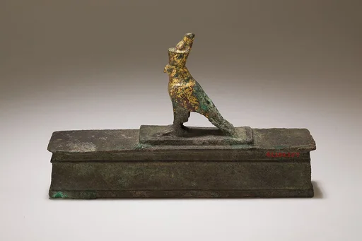 Falcon in double crown surmounting a shrine shaped box for an animal mummy