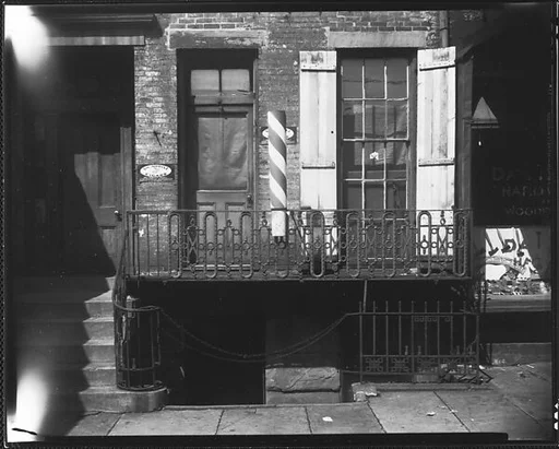 [Abandoned Storefront with Barber Pole in Ground Floor of Residential Building, New York City]