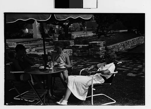 [Two 35mm Film Frames: Women Seated at Outdoor Table with Tennis Court in Distance at Country Club?]